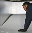 contractor installing TerraBlock™ floor insulation in a Peterborough crawl space