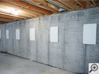 Wall anchor covers installed along a foundation wall that has been straightened in Alliston.