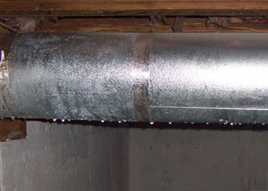 condensation collecting on an HVAC vent in a humid Pickering basement
