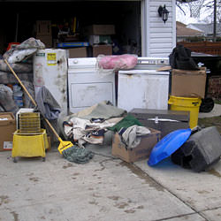 Soaked, wet personal items sitting in a driveway, including a washer and dryer in Richmond Hill.