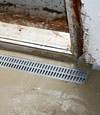 Our grated drain collecting water and directing it into the perimeter basement drainage system.
